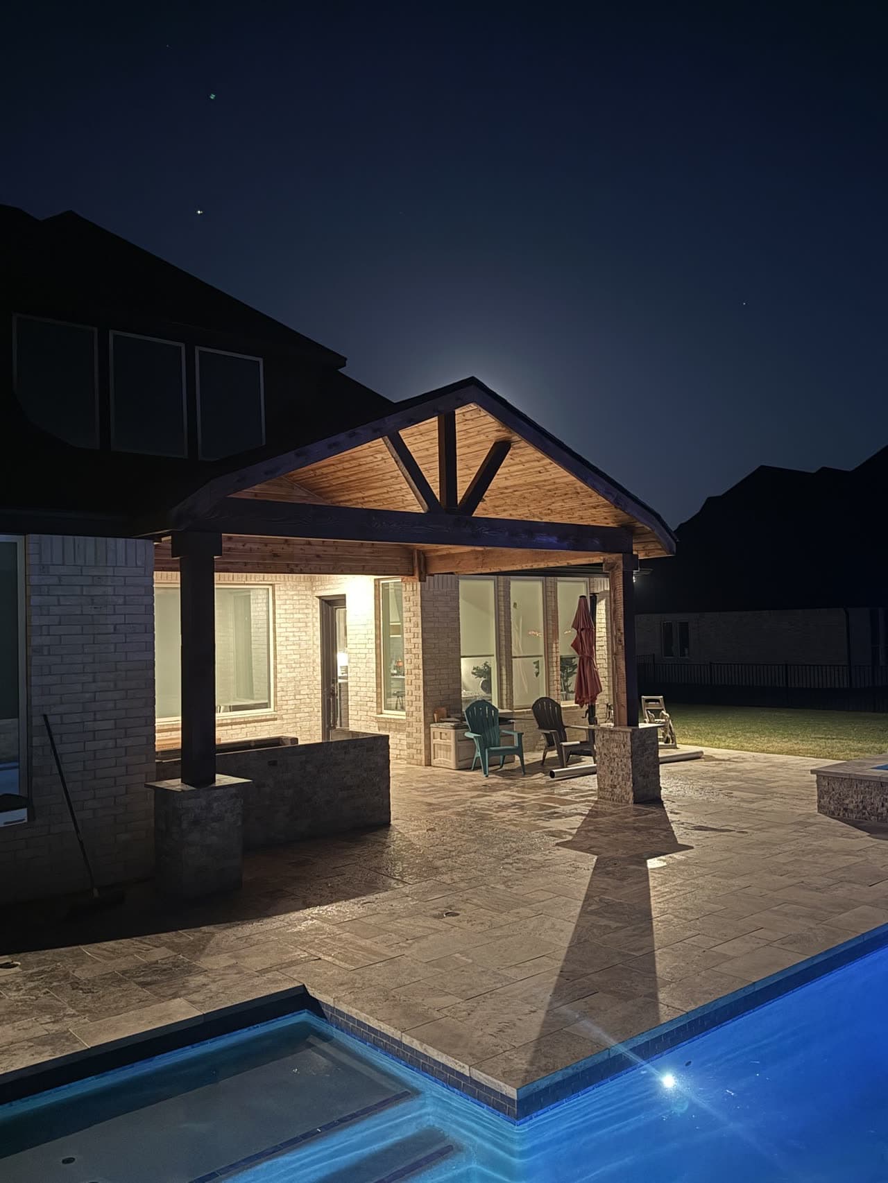 Patio cover by a pool at night
